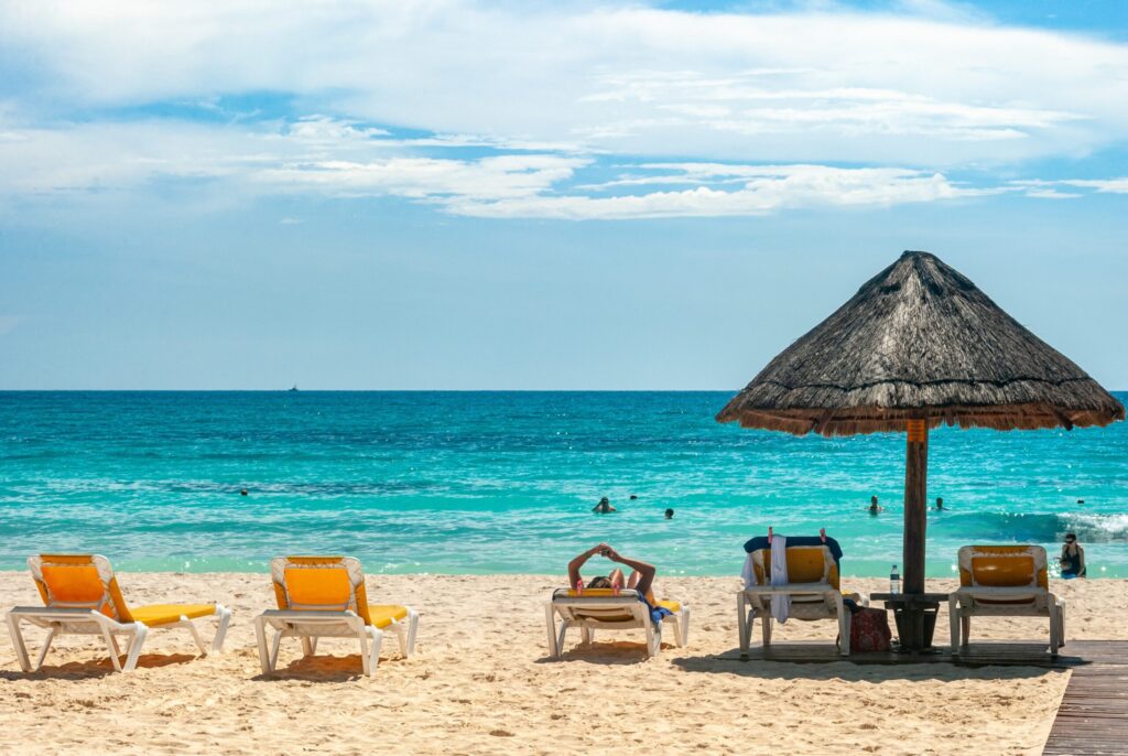 Yellow chairs at the beach with tiki